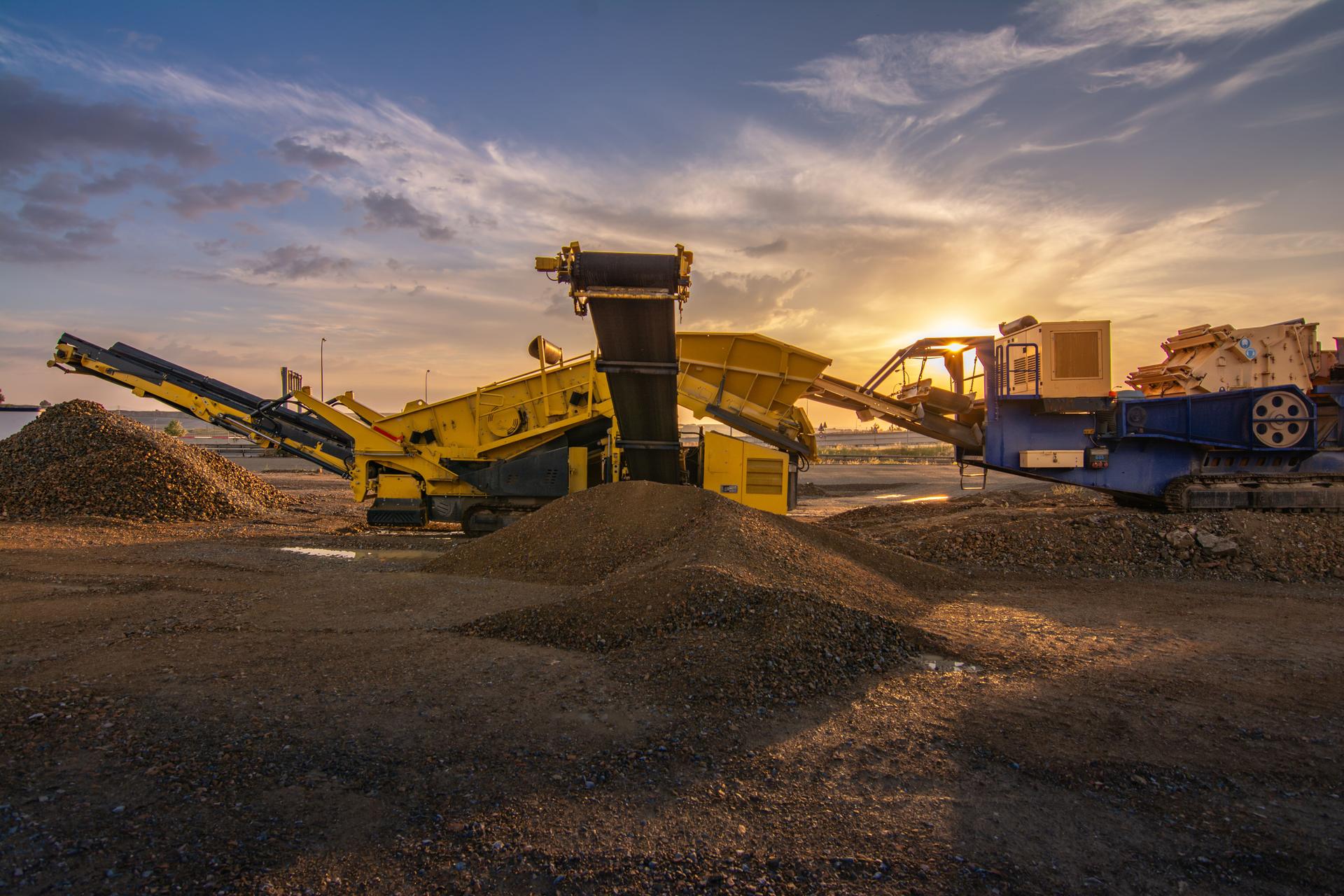Heavy and mobile machinery in a quarry to transform stone into construction material