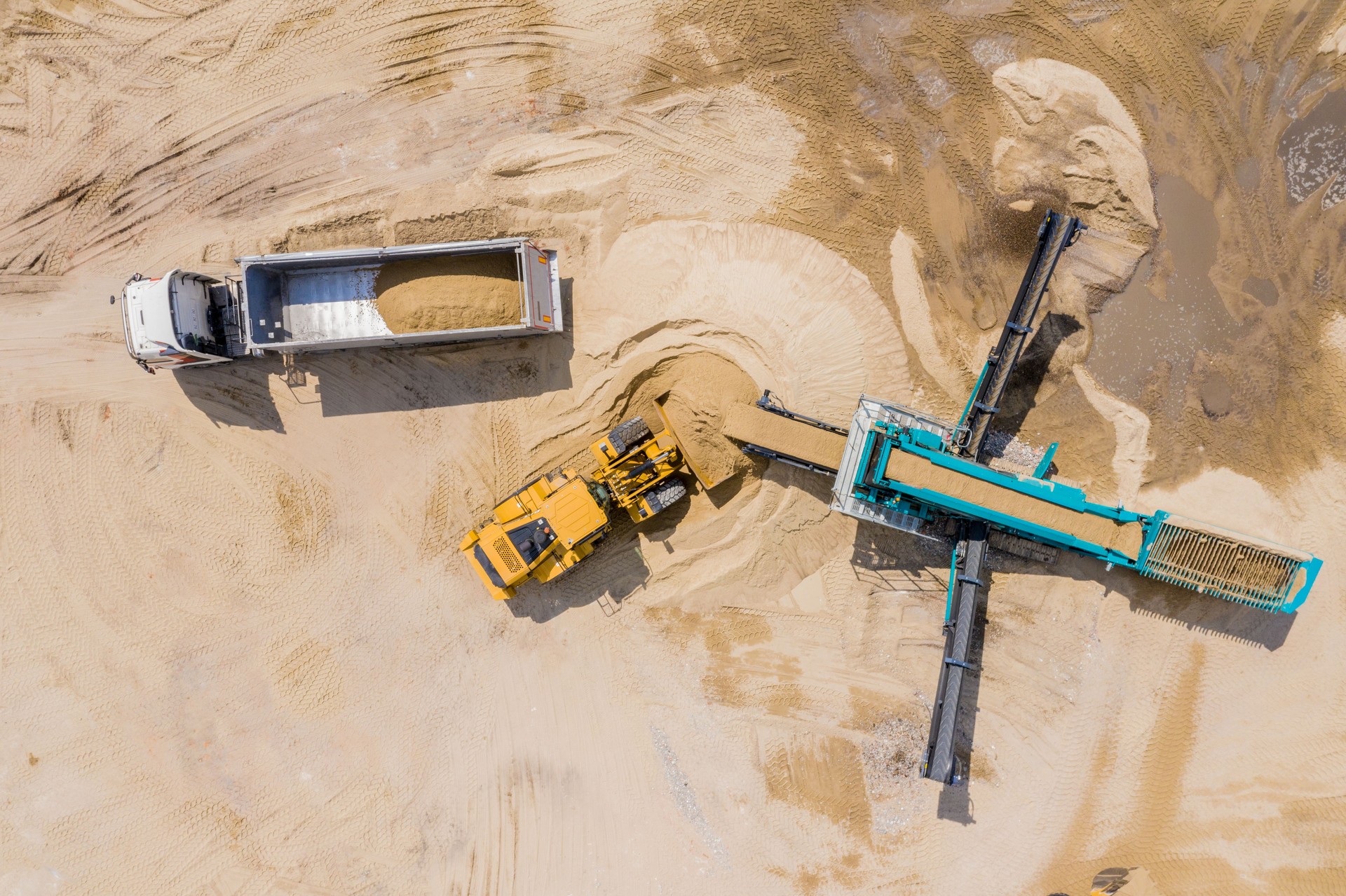 Aerial view of sand quarry with trucks and bulldozers. Heavy bul