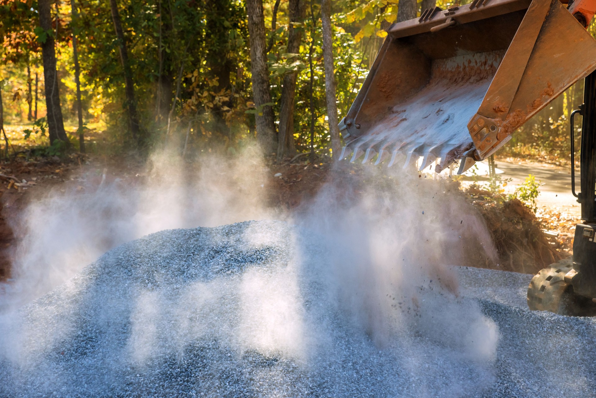 A Bobcat loader excavator was used on a construction site for the purpose of unloading crushed stone for the repair of the road during the repair process.